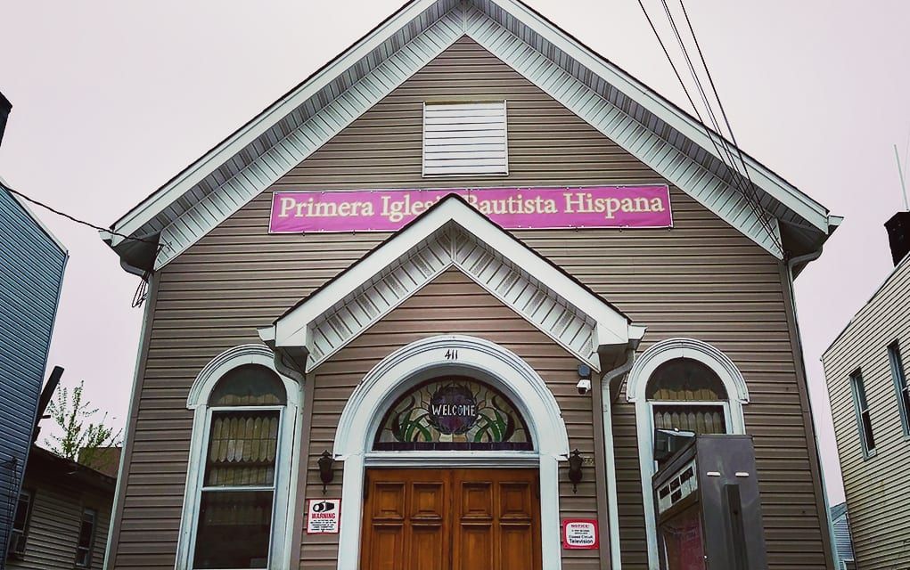 A traditional church building with a hispanic congregation