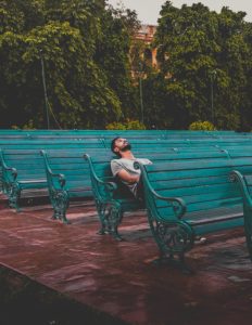 A man sits alone on a bench