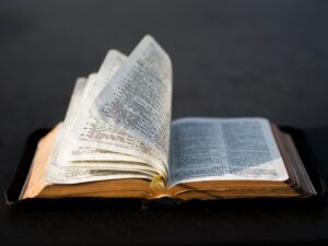A bible sits open with the pages turning