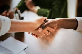 women shaking hands in collaboration