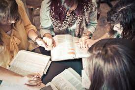a group of people read their bibles together