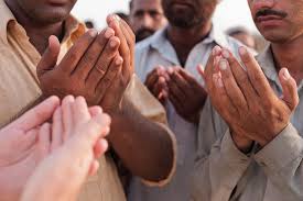 several people are praying together with thier hands clasped