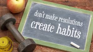 a chalkboard that says "don't make resolutions, make habits."
